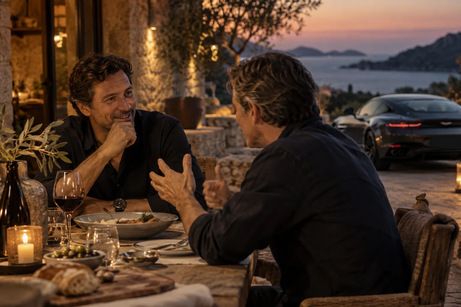 Close view of a warm Italian dinner conversation between two contemporary founders at dusk