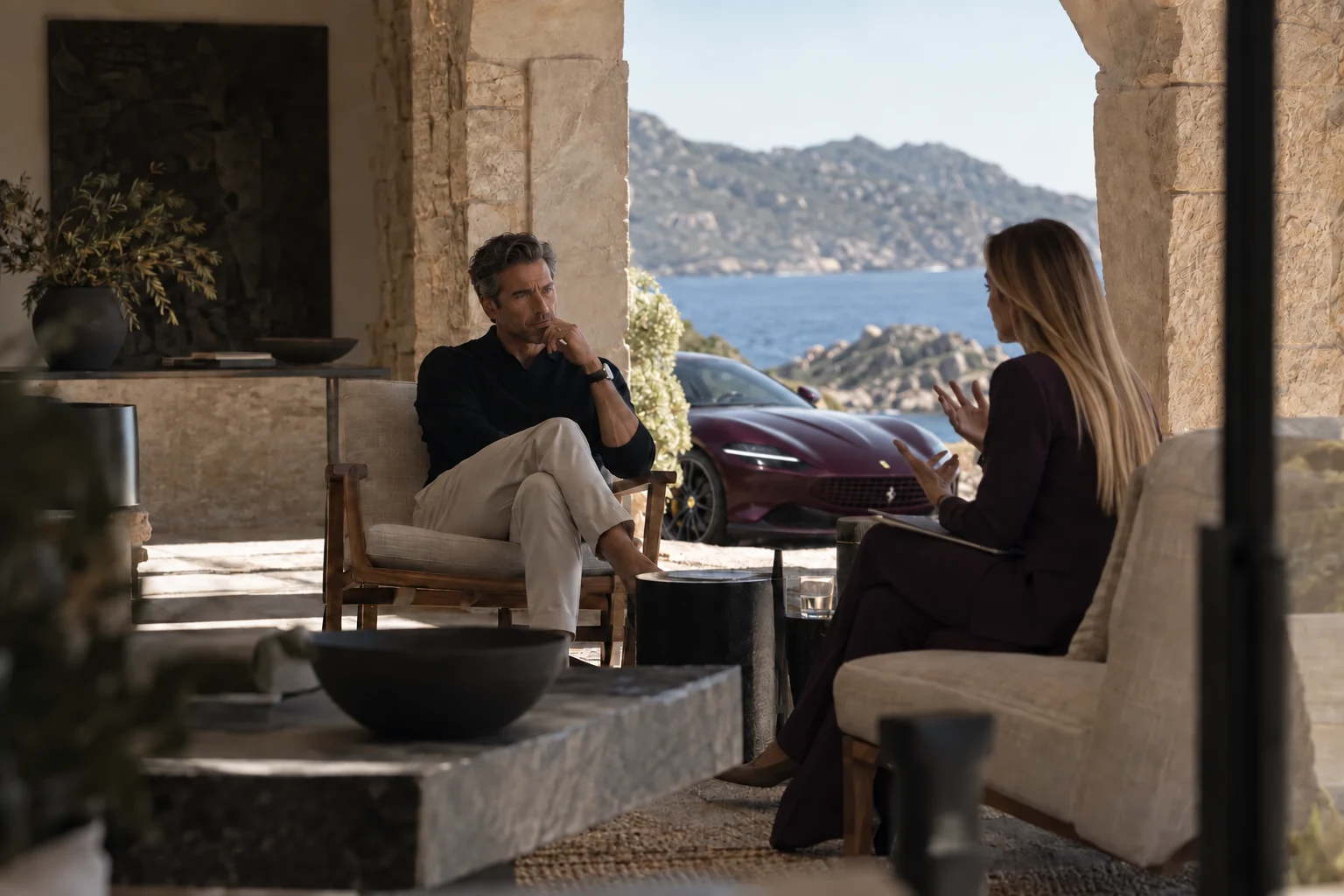 Illustrative scene: Petya in conversation with a founder in a shaded loggia, with a burgundy Ferrari Roma outside